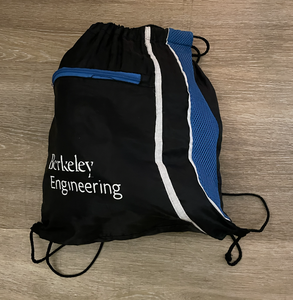 A black drawstring bag with white and blue accents. On the bag is the Berkeley Engineering textmark.